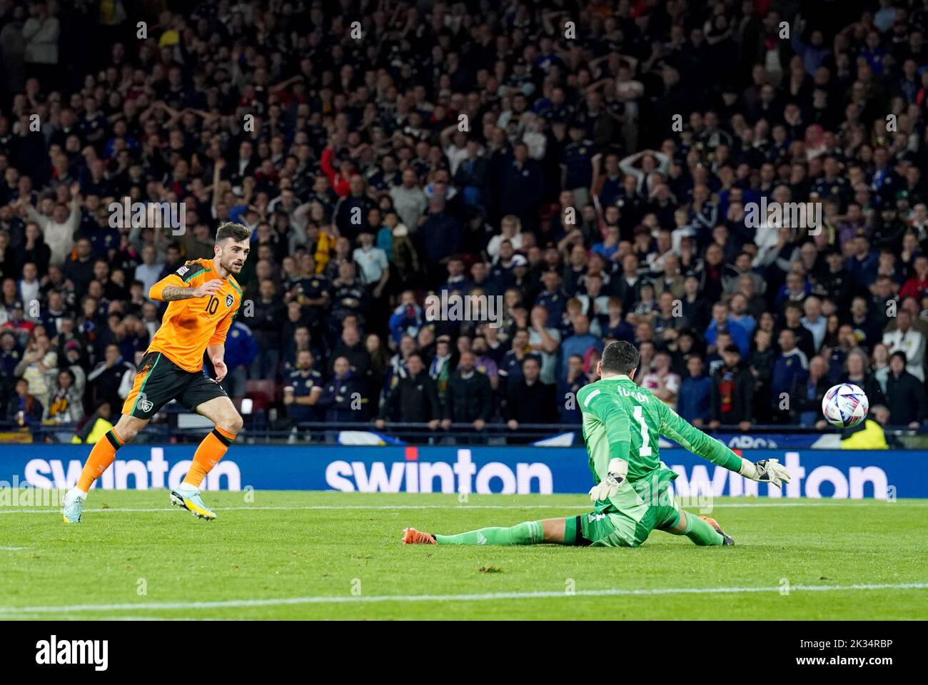 Scotland goalkeeper Craig Gordon (right) saves Republic of Ireland's Troy Parrott's (left) shot during the UEFA Nations League Group E Match at Hampden Park, Glasgow. Picture date: Saturday September 24, 2022. Stock Photo