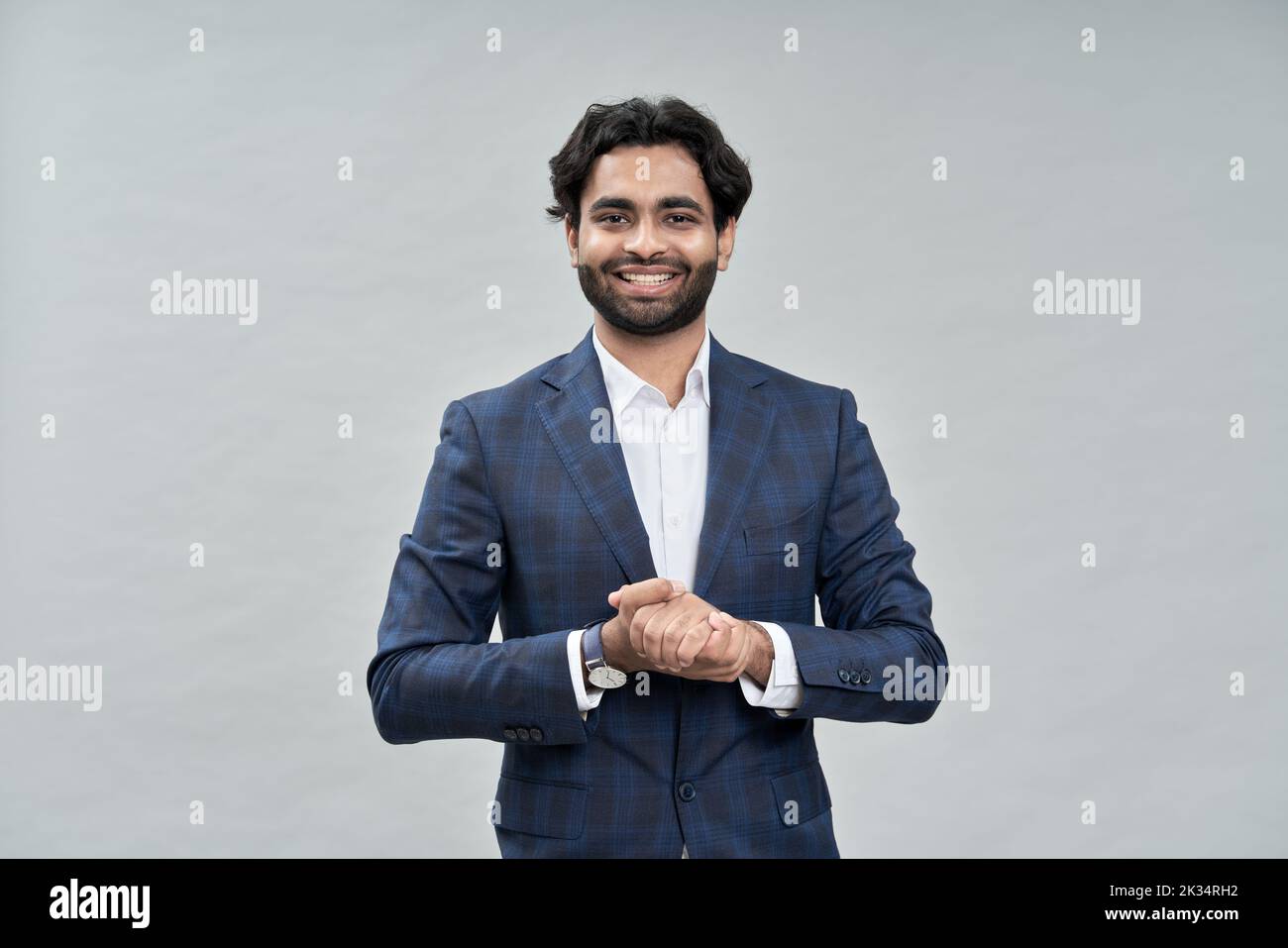 Smiling arab business man salesman wearing suit isolated on beige. Stock Photo
