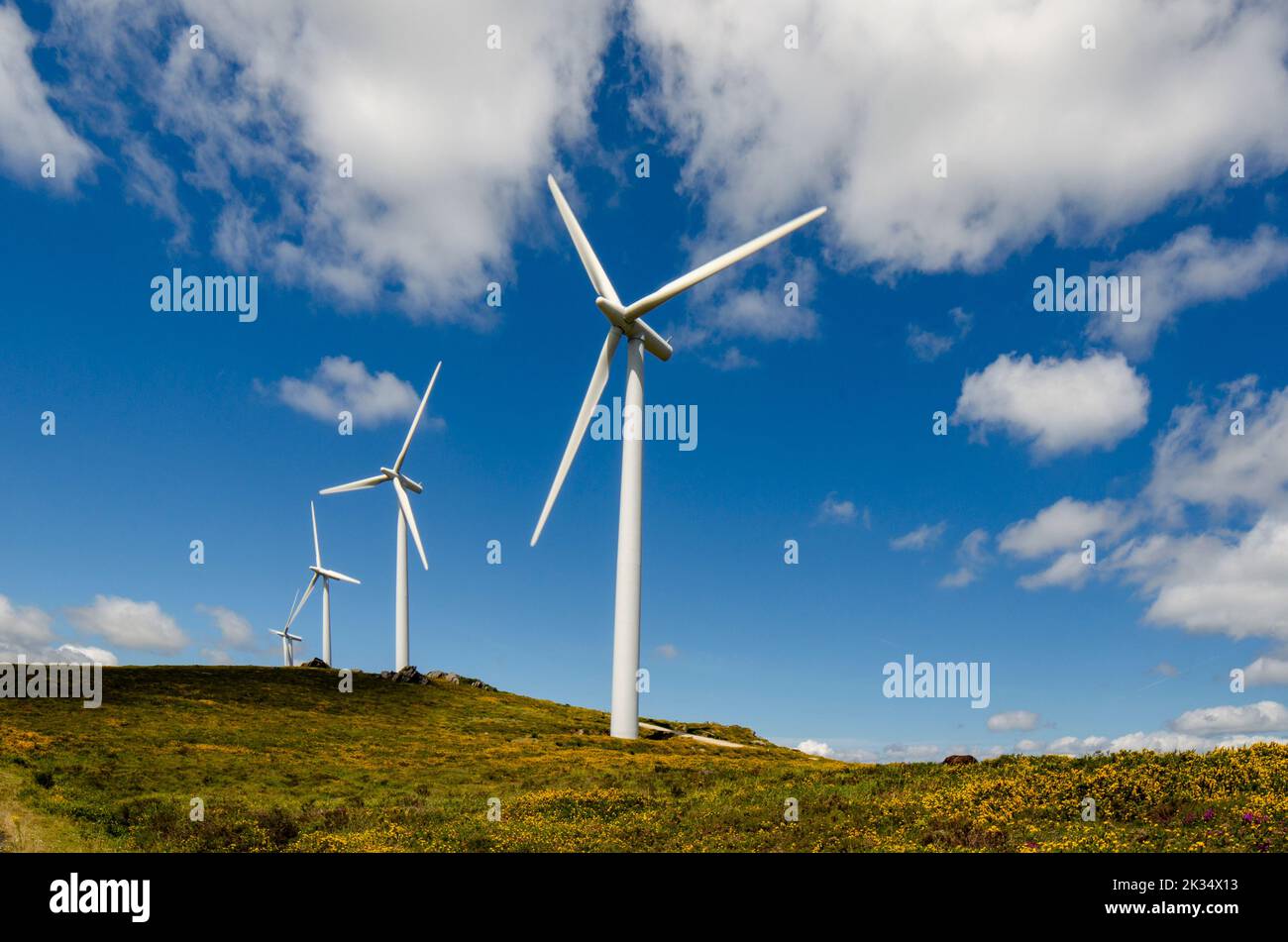view of four wind turbines in the mountains Stock Photo