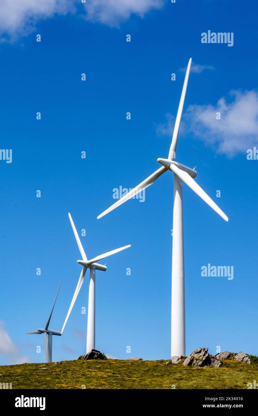 view of three wind turbines in the mountains Stock Photo