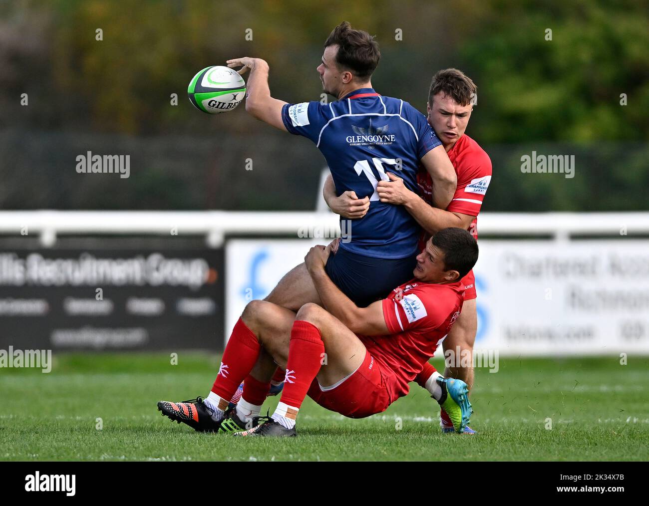 Richmond, United Kingdom. 24th Sep, 2022. Championship Rugby. London Scottish V Jersey Reds. The Richmond Athletic Ground. Richmond. Cam Anderson (London Scottish) is tackled by Russell Bennett (Jersey Reds, lower) and Charlie Powell (Jersey Reds) during the London Scottish V Jersey Reds championship rugby match. Credit: Sport In Pictures/Alamy Live News Stock Photo