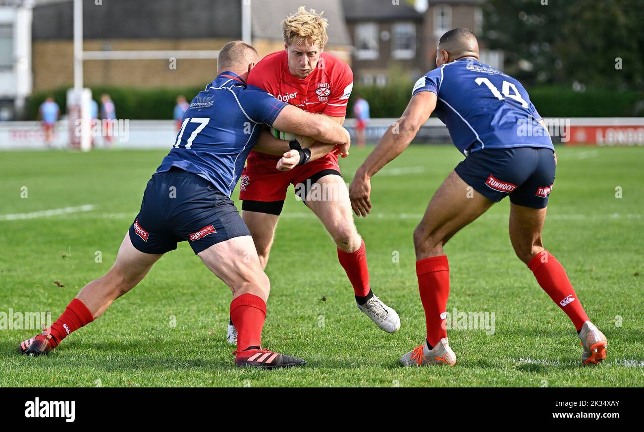 Richmond, United Kingdom. 24th Sep, 2022. Championship Rugby. London Scottish V Jersey Reds. The Richmond Athletic Ground. Richmond. Scott van Breda (Jersey Reds) is tackled by Jordan Els (London Scottish, 17) and Noah Ferdinand (London Scottish) during the London Scottish V Jersey Reds championship rugby match. Credit: Sport In Pictures/Alamy Live News Stock Photo