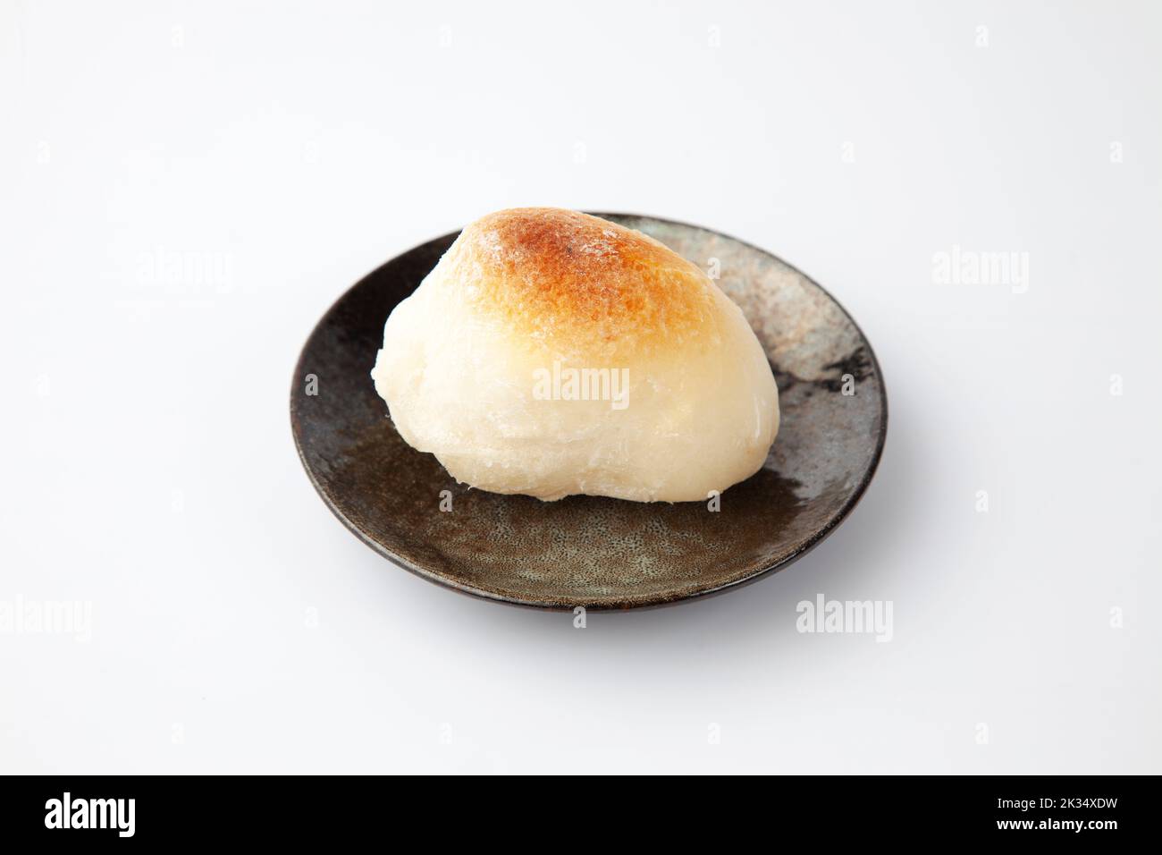baked rice cake on plate isolated on white background Stock Photo - Alamy
