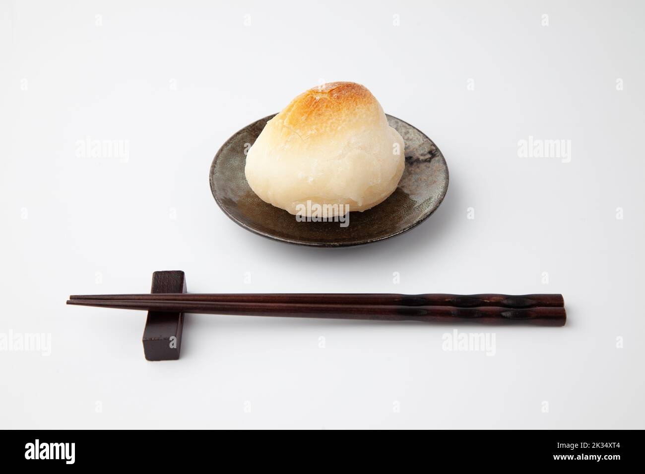 baked rice cake on plate isolated on white background Stock Photo - Alamy