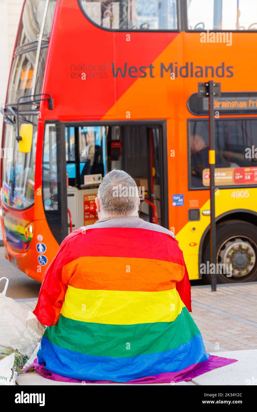 double decker west midlands bus livery with and older man draped  pride flag LGBT Gay Pride parade  2022 in birmingham city centre uk september 24th Stock Photo