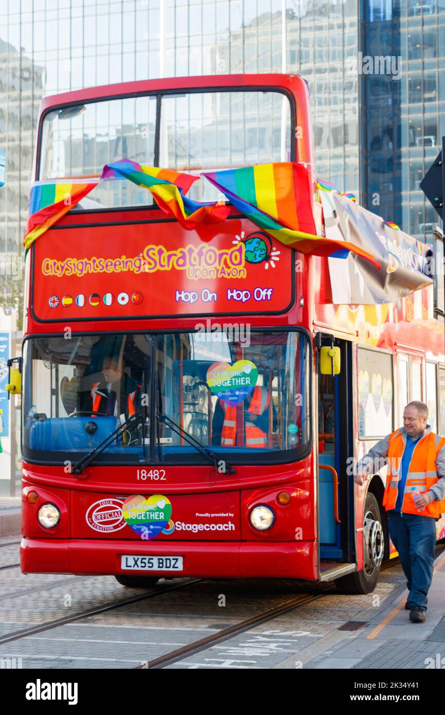 red double decker bus with pride flags livery at Gay Pride parade protest 2022 in birmingham city centre uk september 24th Stock Photo