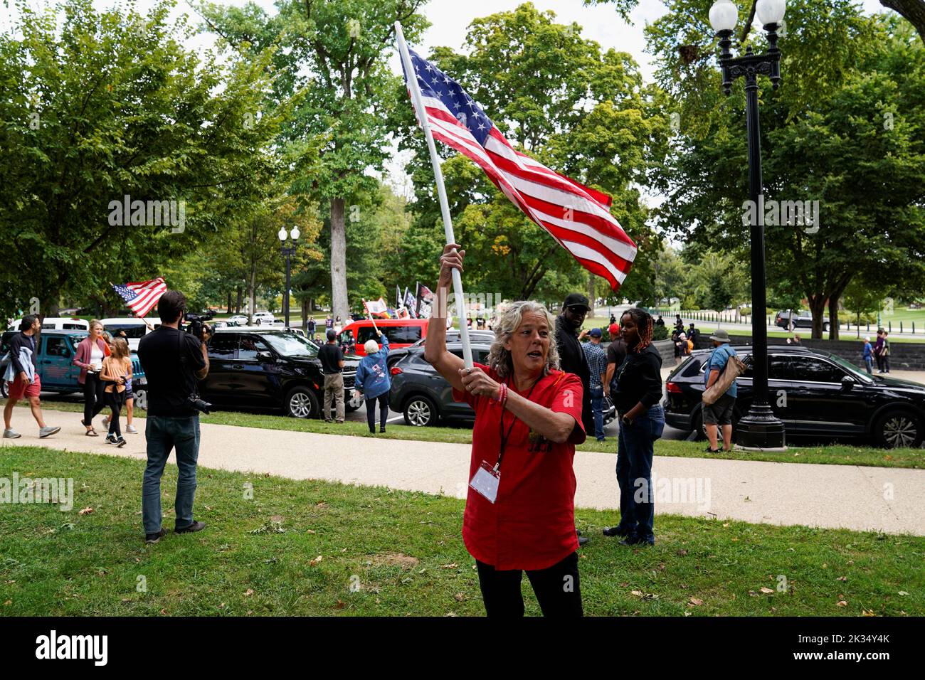 Micki Witthoeft, the mother of Ashli Babbitt who was shot and killed during the January 6th attack on the U.S. Capitol, waves a flag as counter protesters gather across the street during an event supporting the people charged with crimes related to the January 6th, 2021 attack on the U.S. Capitol, in Washington, U.S., September 24, 2022. REUTERS/Elizabeth Frantz Stock Photo