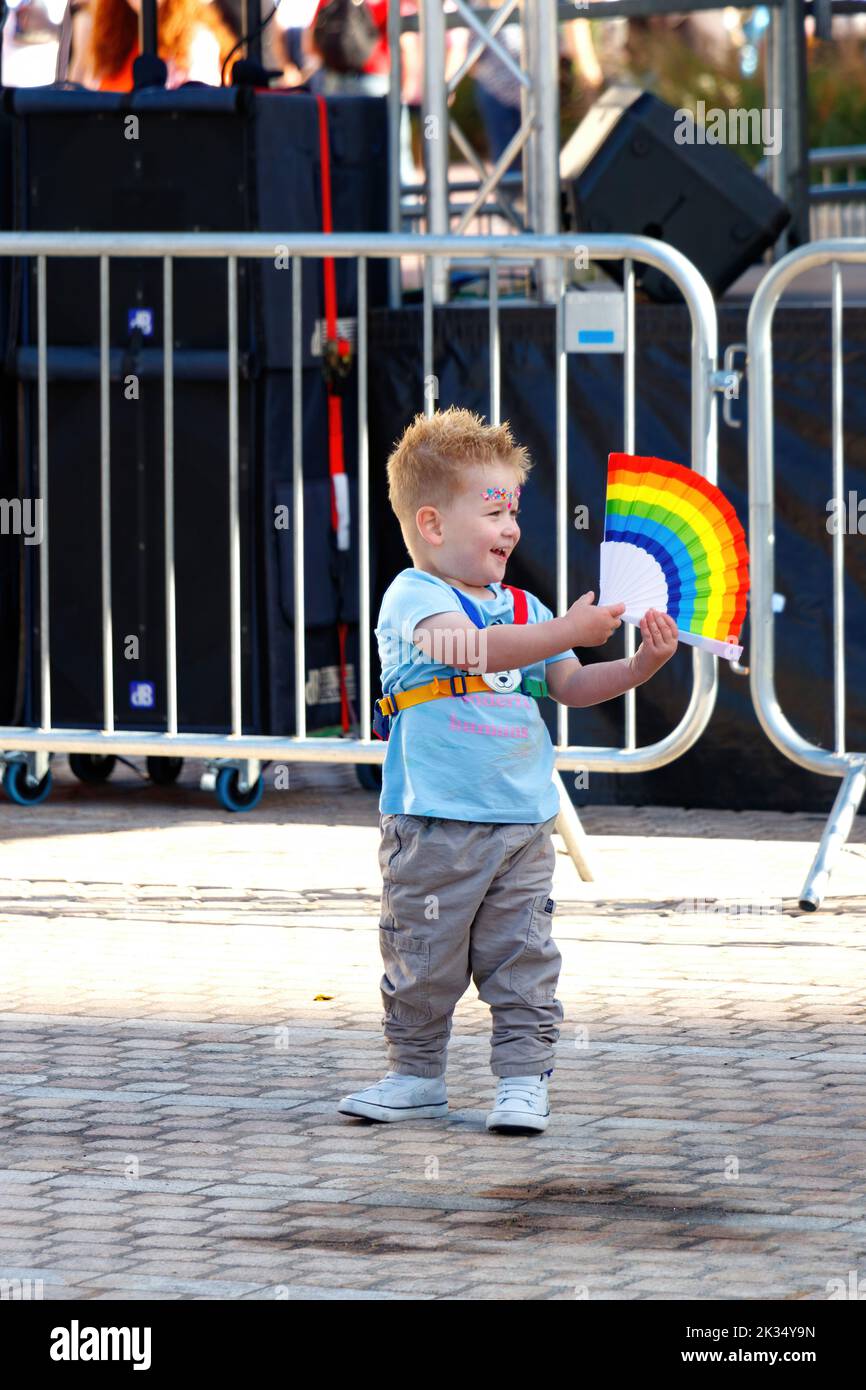 toddler boy with rainbow fan at Gay Pride parade protest 2022 in birmingham city centre uk september 24th Stock Photo