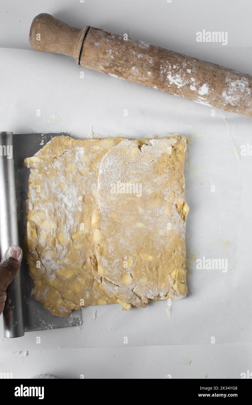 danish pastry dough being laminated, pastry dough with pieces of cold