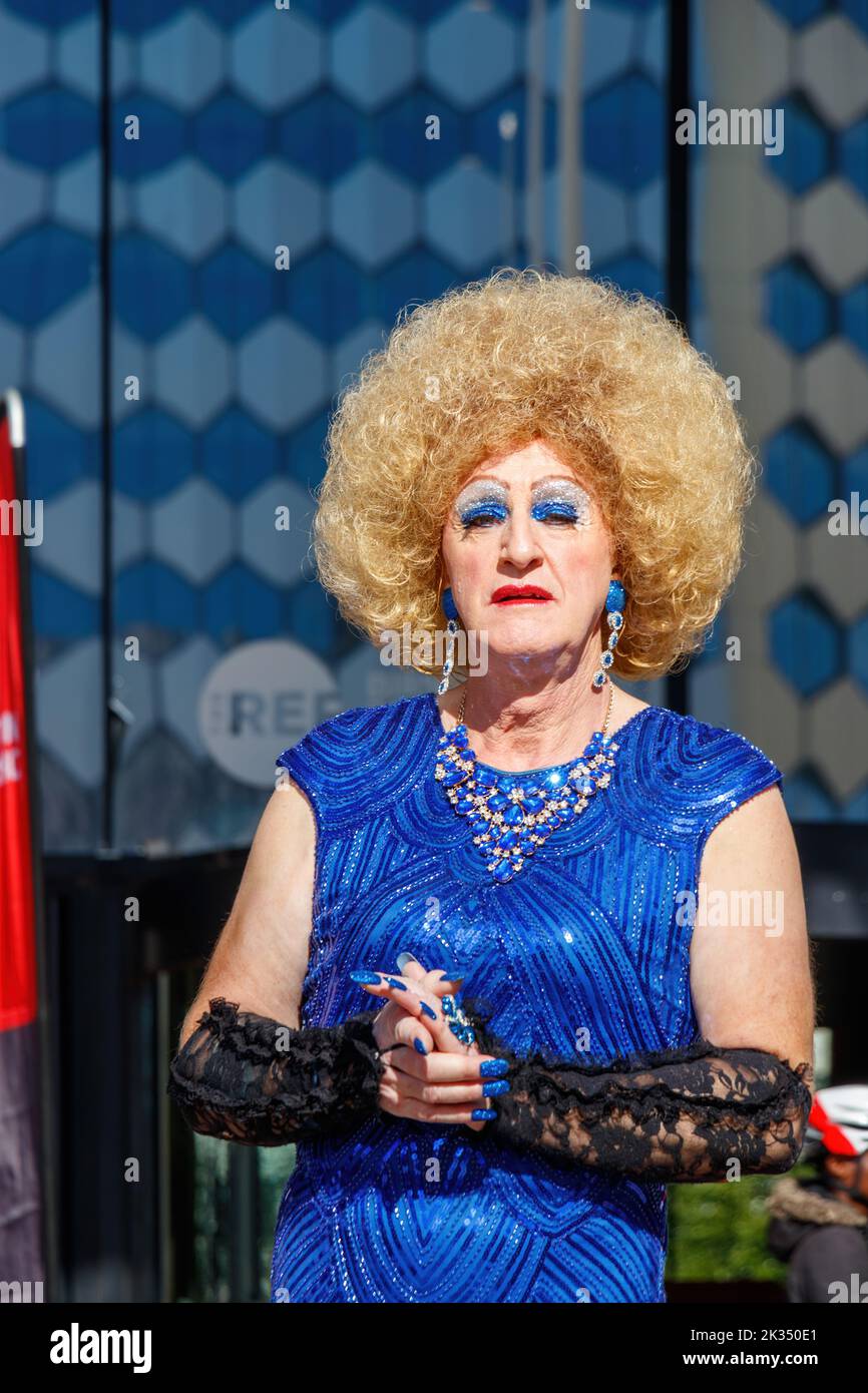 trans woman in drag  wearing blonde wig and sparkly blue dress at Gay Pride parade protest 2022 in birmingham city centre uk september 24th Stock Photo