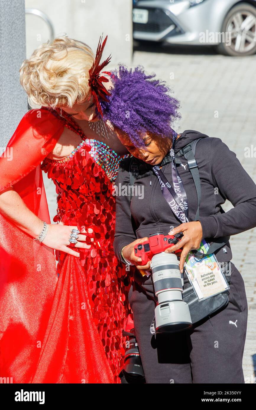 trans woman in drag looks at professional photographers camera at Gay Pride parade protest 2022 in birmingham city centre uk september 24th Stock Photo