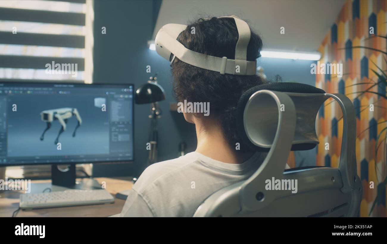 Man playing video game using modern VR headset and wireless controllers ...