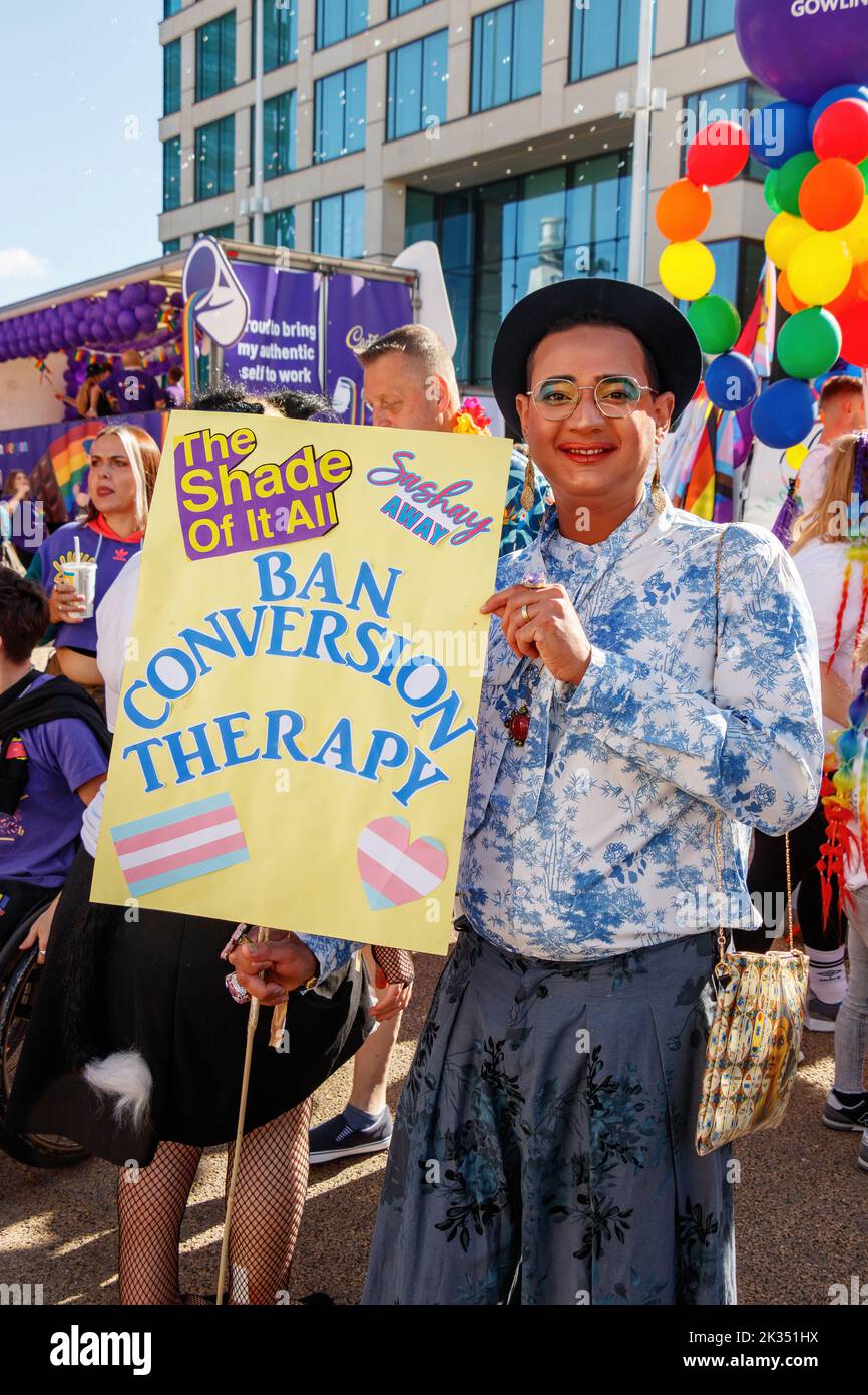 man wearing makeup with sign protesting ban conversion therapy at Gay Pride parade protest 2022 in birmingham city centre uk september 24th Stock Photo