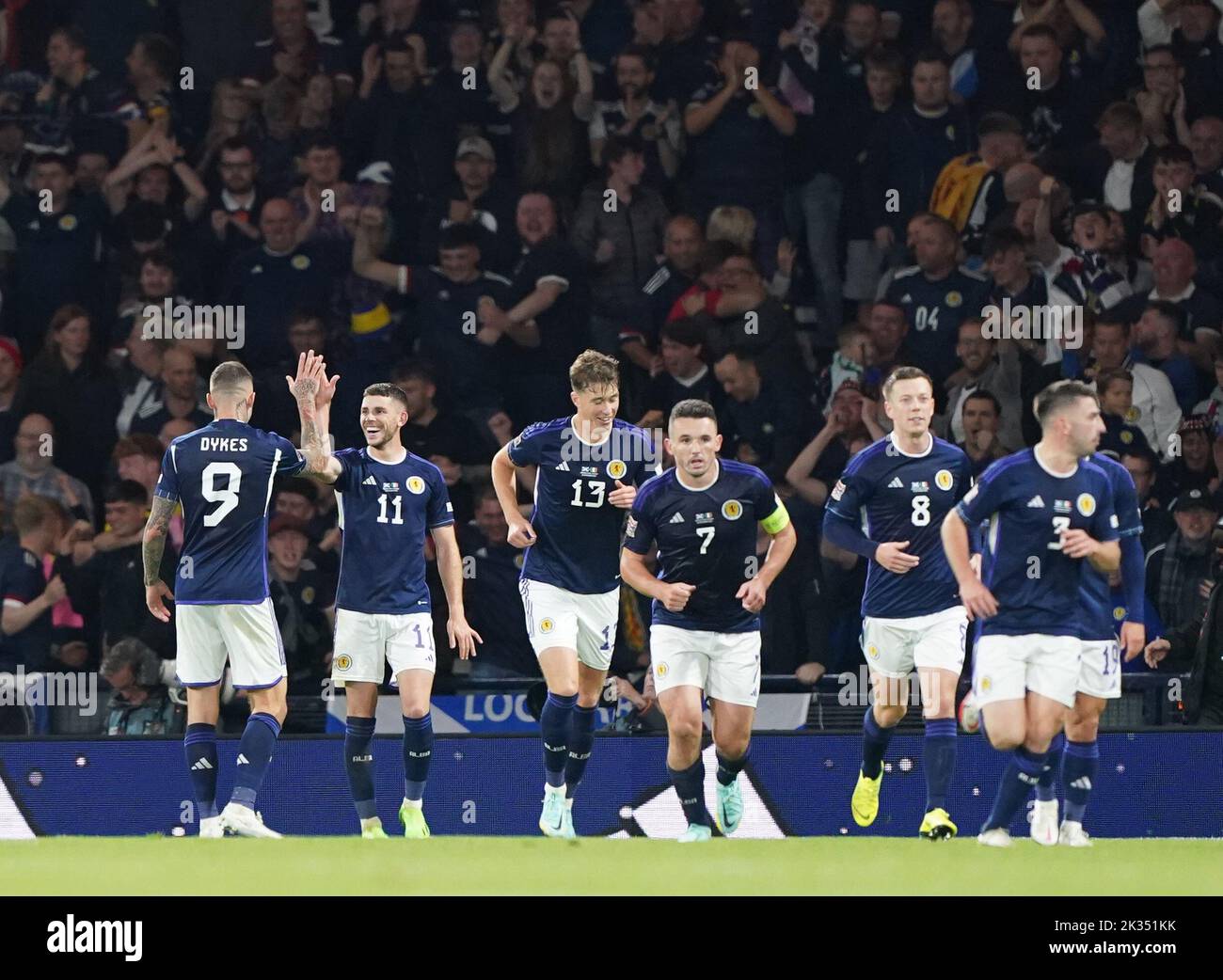 Scotland's Ryan Christie (second left) celebrates with Lyndon Dykes (left) after scoring his sides second goal of the game during the UEFA Nations League Group E Match at Hampden Park, Glasgow. Picture date: Saturday September 24, 2022. Stock Photo