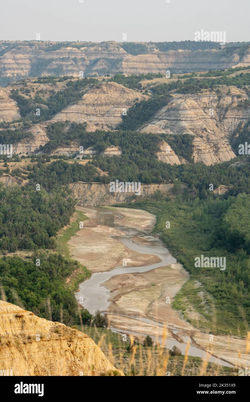 Little MIssouri River Flows Below Badlands Formations in Theodore Roosevelt National Park Stock Photo