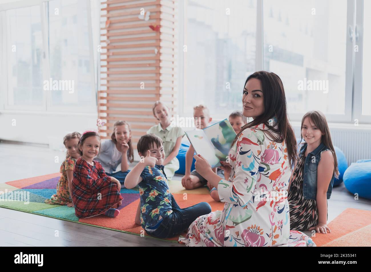 Reading time in an elementary school or kindergarten, a teacher reads a