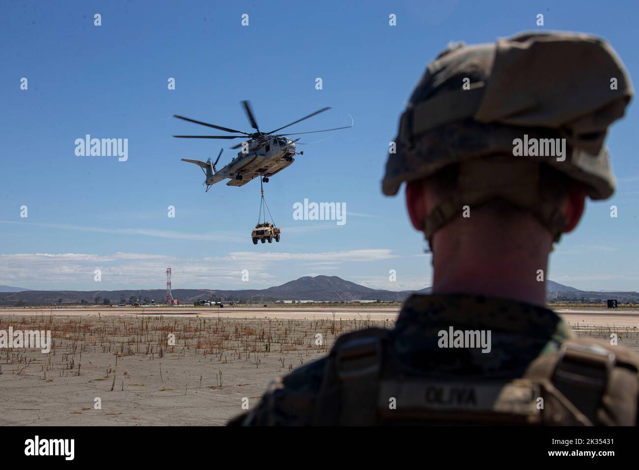 U.S. Marines with Helicopter Support Team, 1st Landing Battalion, 1st Marine Logistics Group, stand by for the drop off of a Joint Light Tactical Vehicle from Marine Heavy Helicopter Squadron 465 during the Marine Air-Ground Task Force demonstration of the 2022 Marine Corps Air Station Miramar Air Show at MCAS Miramar, San Diego, California, Sept. 22, 2022. The MAGTF Demo displays the coordinated use of close-air support, artillery and infantry forces, and provides a visual representation of how the Marine Corps operates. The theme for the 2022 MCAS Miramar Air Show, “Marines Fight, Evolve and Stock Photo