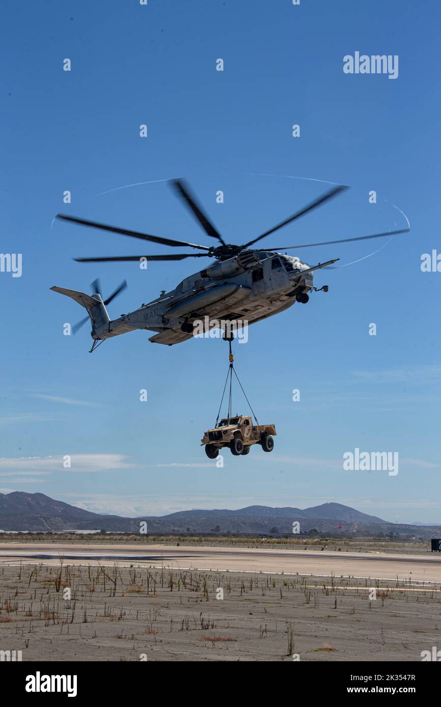 A Sikorsky CH-53E Super Stallion with Marine Heavy Helicopter Squadron 465, 3rd Marine Air Wing, carries a Joint Light Tactical Vehicle during the Marine Air-Ground Task Force demonstration of the 2022 Marine Corps Air Station Miramar Air Show at MCAS Miramar, San Diego, California, Sept. 22, 2022. The MAGTF Demo displays the coordinated use of close-air support, artillery and infantry forces, and provides a visual representation of how the Marine Corps operates. The theme for the 2022 MCAS Miramar Air Show, “Marines Fight, Evolve and Win,” reflects the Marine Corps’ ongoing modernization effo Stock Photo