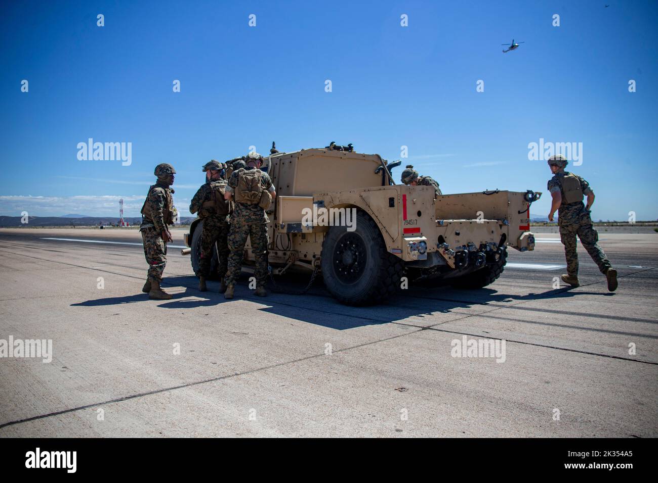 U.S. Marines with Helicopter Support Team, 1st Landing Battalion, 1st Marine Logistics Group, work to recover a Joint Light Tactical Vehicle during the Marine Air-Ground Task Force demonstration of the 2022 Marine Corps Air Station Miramar Air Show at MCAS Miramar, San Diego, California, Sept. 22, 2022. The MAGTF Demo displays the coordinated use of close-air support, artillery and infantry forces, and provides a visual representation of how the Marine Corps operates. The theme for the 2022 MCAS Miramar Air Show, “Marines Fight, Evolve and Win,” reflects the Marine Corps’ ongoing modernization Stock Photo