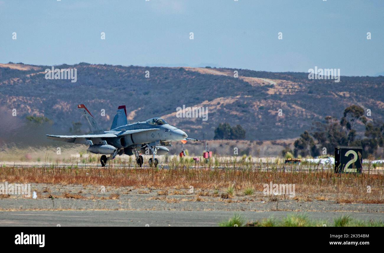 An F/A-18 Hornet takes off during the Marine Air-Ground Task Force demonstration of the 2022 Marine Corps Air Station Miramar Air Show at MCAS Miramar, San Diego, California, Sept. 23, 2022. The MAGTF Demo displays the coordinated use of close-air support, artillery and infantry forces, and provides a visual representation of how the Marine Corps operates. The theme for the 2022 MCAS Miramar Air Show, “Marines Fight, Evolve and Win,” reflects the Marine Corps’ ongoing modernization efforts to prepare for future conflicts. (U.S. Marine Corps photo by Lance Cpl. Zachary Larsen) Stock Photo