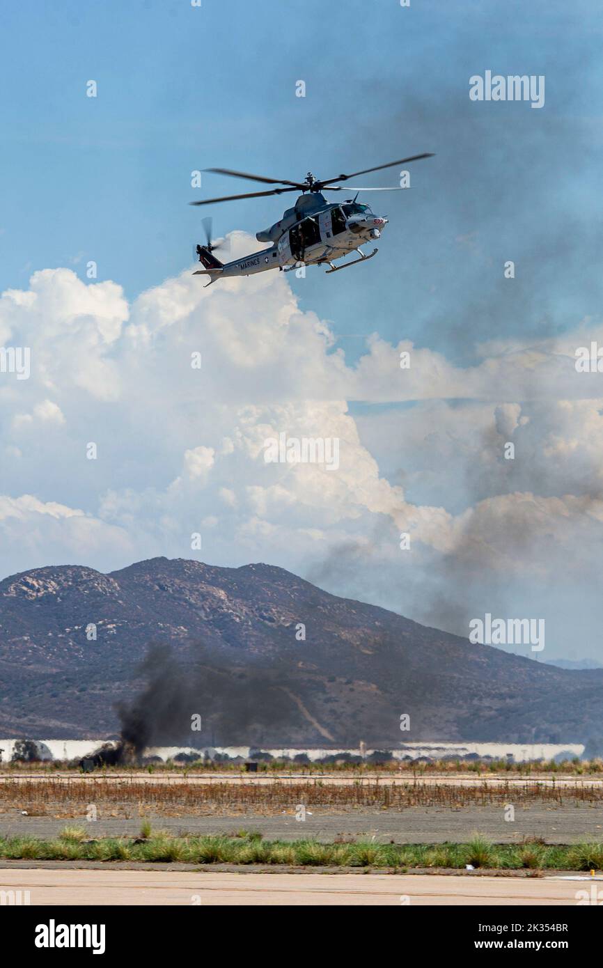 A Bell UH-1Y Venom flies above the flight line during the Marine Air-Ground Task Force demonstration of the 2022 Marine Corps Air Station Miramar Air Show at MCAS Miramar, San Diego, California, Sept. 23, 2022. The MAGTF Demo displays the coordinated use of close-air support, artillery and infantry forces, and provides a visual representation of how the Marine Corps operates. The theme for the 2022 MCAS Miramar Air Show, “Marines Fight, Evolve and Win,” reflects the Marine Corps’ ongoing modernization efforts to prepare for future conflicts. (U.S. Marine Corps photo by Lance Cpl. Zachary Larse Stock Photo