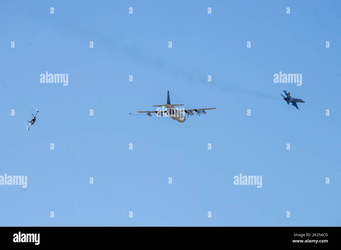 A C-130 Hercules and F/A-18 Hornets fly above the flight line during the Marine Air-Ground Task Force demonstration of the 2022 Marine Corps Air Station Miramar Air Show at MCAS Miramar, San Diego, California, Sept. 23, 2022. The MAGTF Demo displays the coordinated use of close-air support, artillery and infantry forces, and provides a visual representation of how the Marine Corps operates. The theme for the 2022 MCAS Miramar Air Show, “Marines Fight, Evolve and Win,” reflects the Marine Corps’ ongoing modernization efforts to prepare for future conflicts. (U.S. Marine Corps photo by Lance Cpl Stock Photo