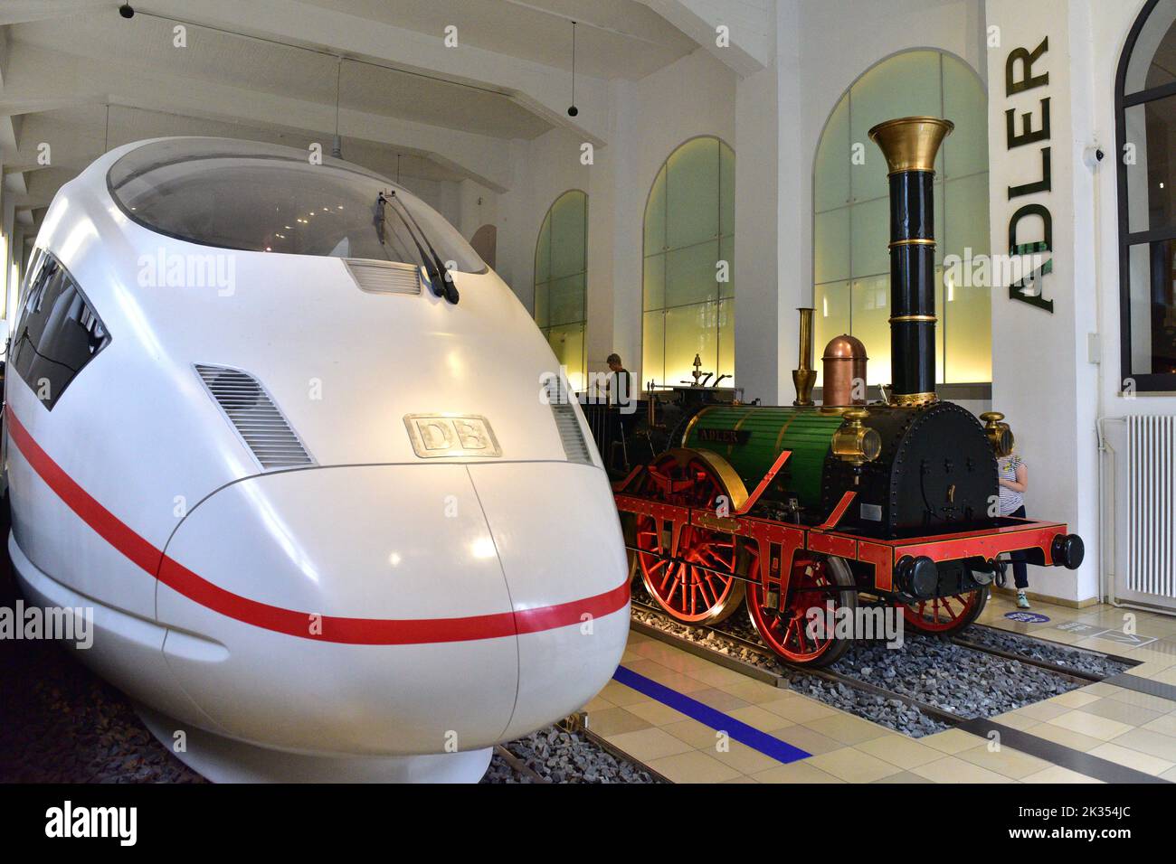 Museum of the Deutsche Bahn in Nuremberg - the modern ICE next to a replica of the first German locomotive Adler Stock Photo