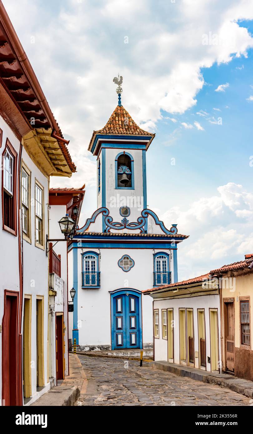 Street with cobblestones and colonial-style houses with a historic church in the background in the famous city of Diamantina in Minas Gerais Stock Photo