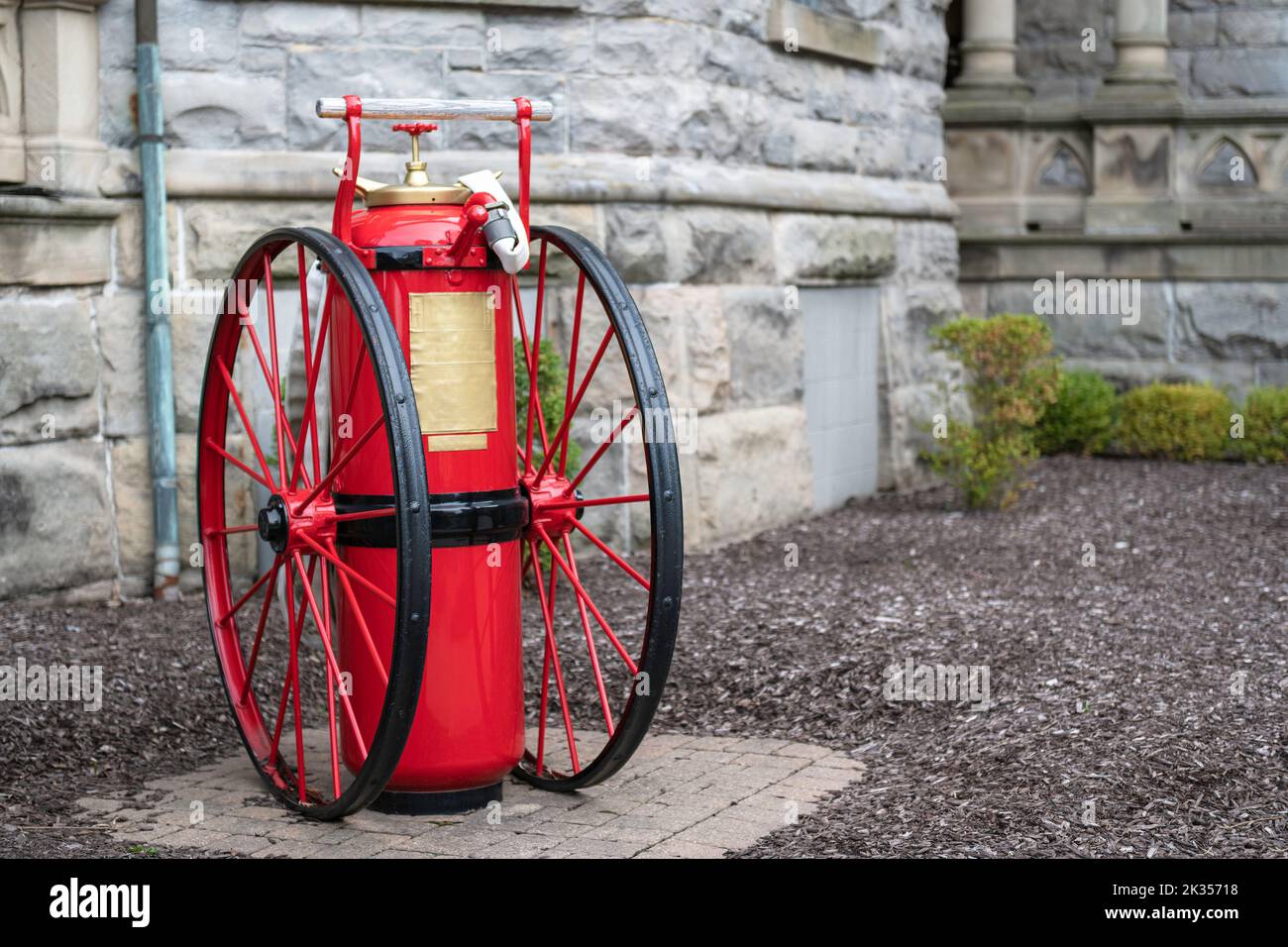 Large antique fire extinguisher on wheels Stock Photo