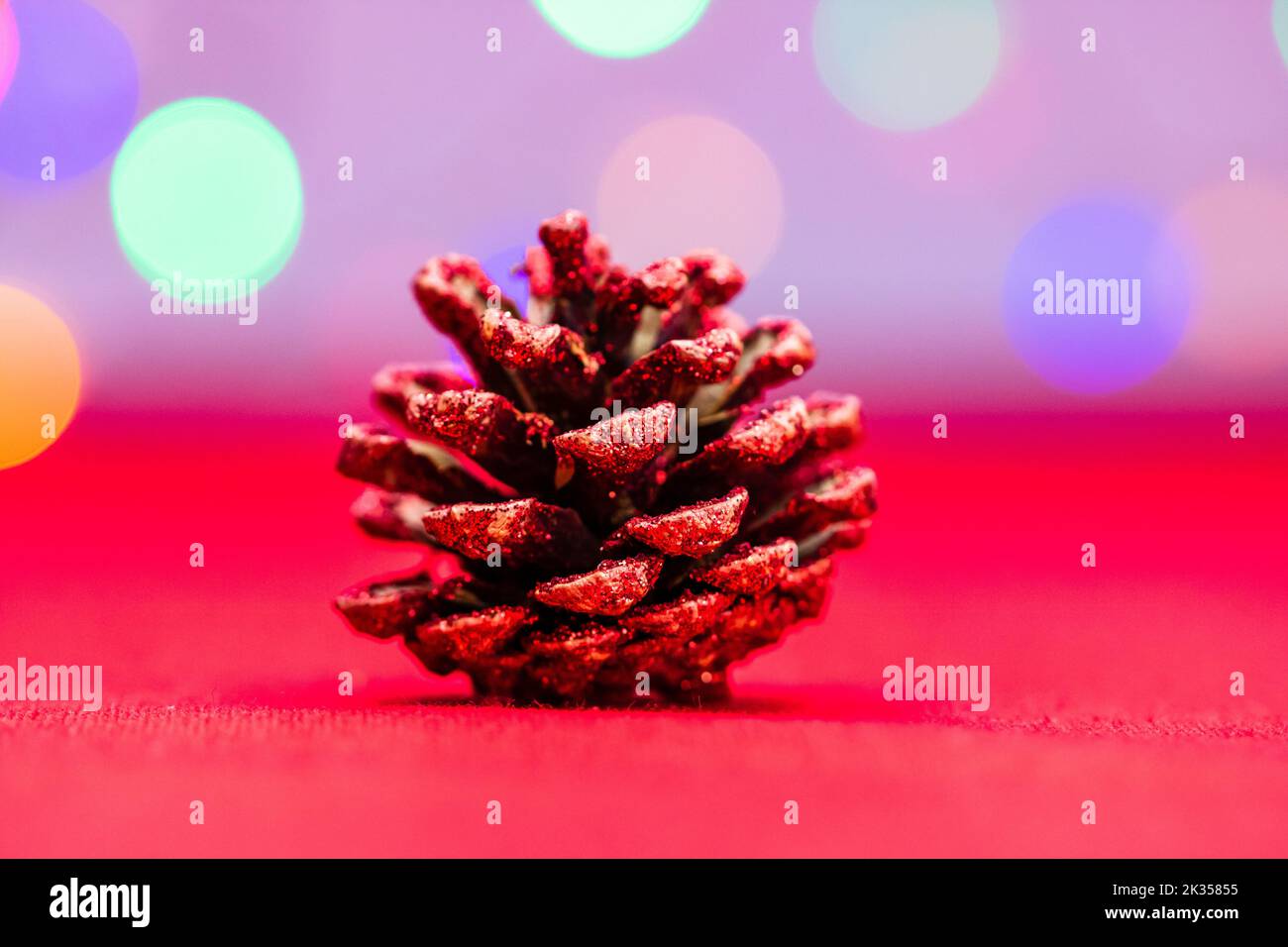 A pine cone Christmas decoration on bokeh lights background Stock Photo ...