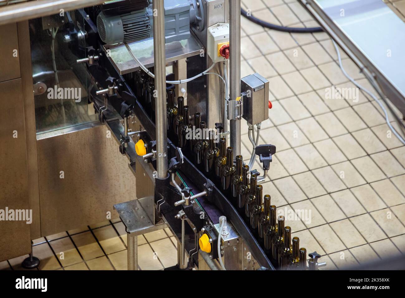 Bottling and sealing wine conveyor production line at modern winery Stock Photo