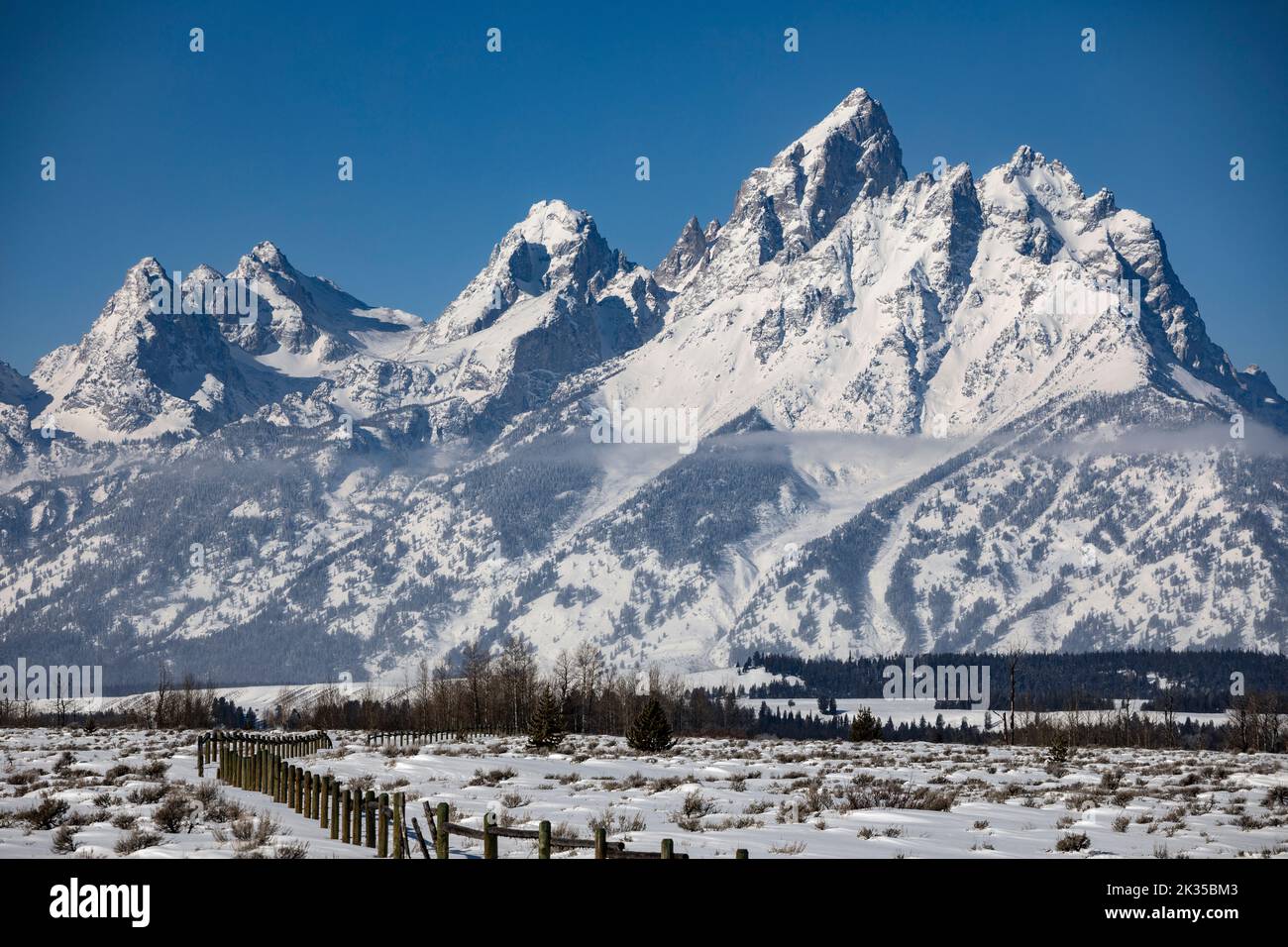 WY05076-00.....WYOMING - View of the Teton Range in winter from Cunningham Cabin Historic Site in Grand Teton National Park. Stock Photo