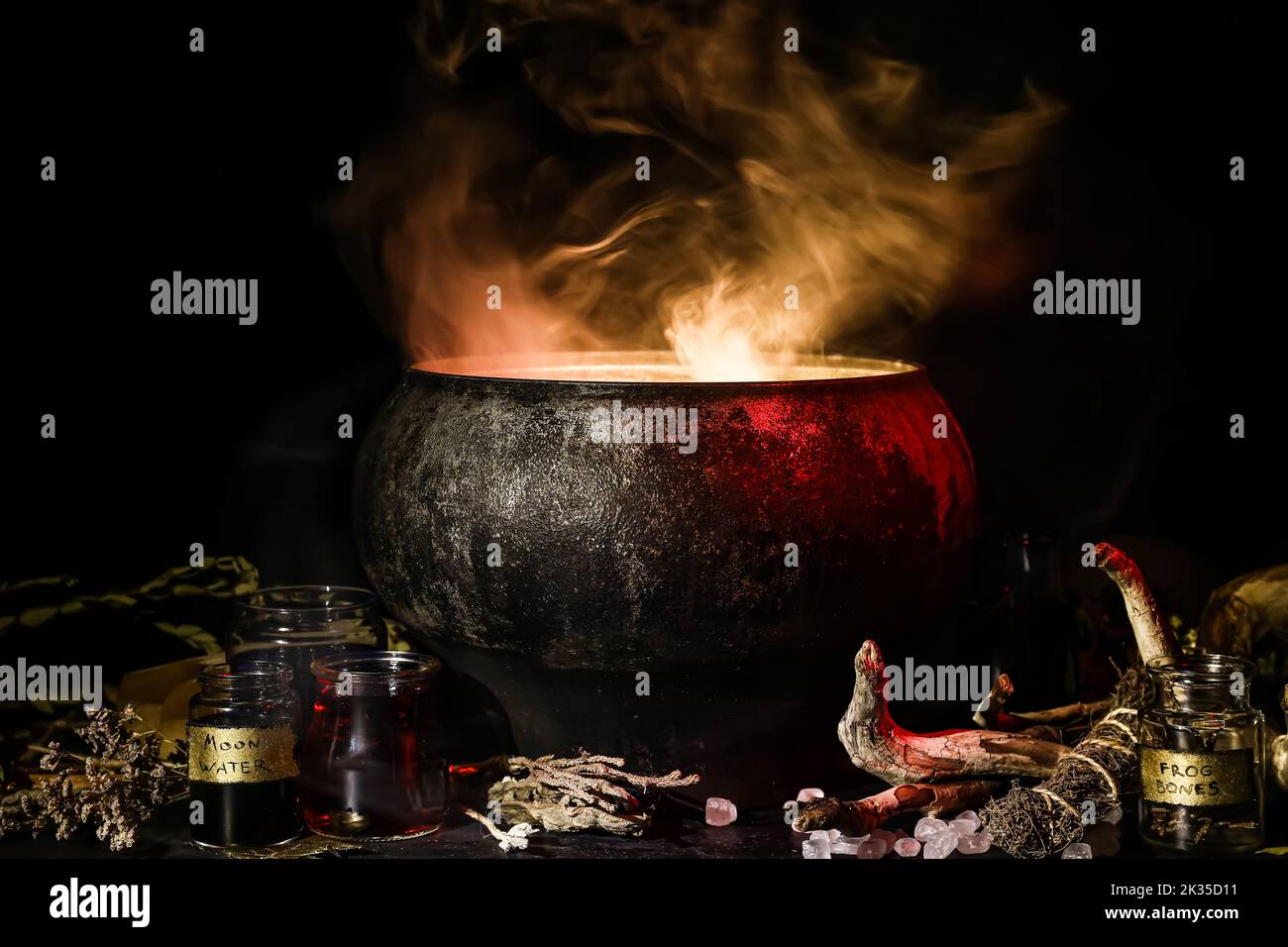 Witch's cauldron with potion and different magic attributes for ritual ...