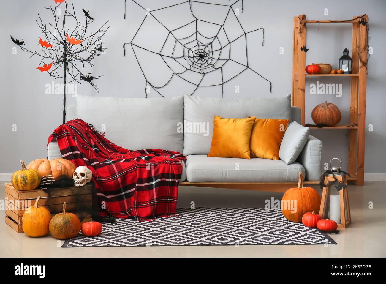 Interior of living room decorated for Halloween with grey sofa and ...