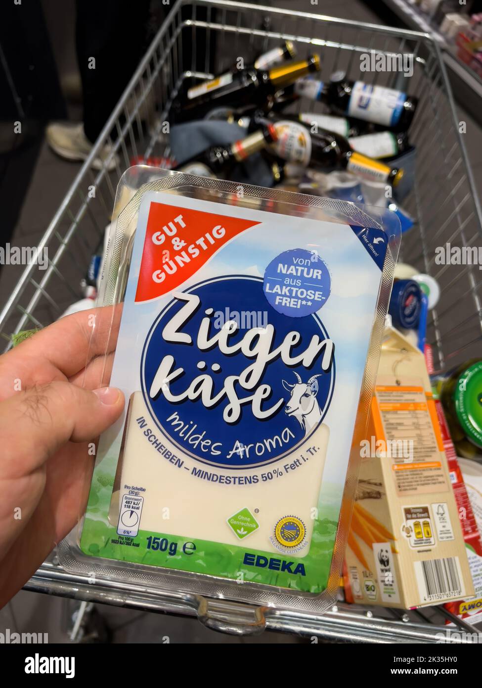 Frankfurt, Germany Sep 17, 2022 POV male hand holding Ziegen Kase goat cheese gut und gunstig