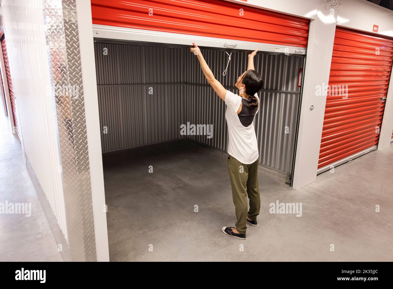 Woman opening empty storage facility locker Stock Photo Alamy