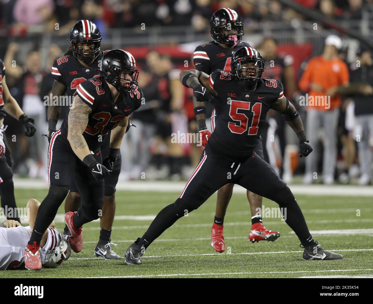 Columbus, United States. 24th Sep, 2022. The Ohio State Buckeyes Mike Hall Jr (51) and Jack Sawyer (33) celebrate a sack on Wisconsin Badgers Graham Mertz (5) in the first half in Columbus, Ohio on Saturday, September 24, 2022. Photo by Aaron Josefczyk/UPI Credit: UPI/Alamy Live News Stock Photo