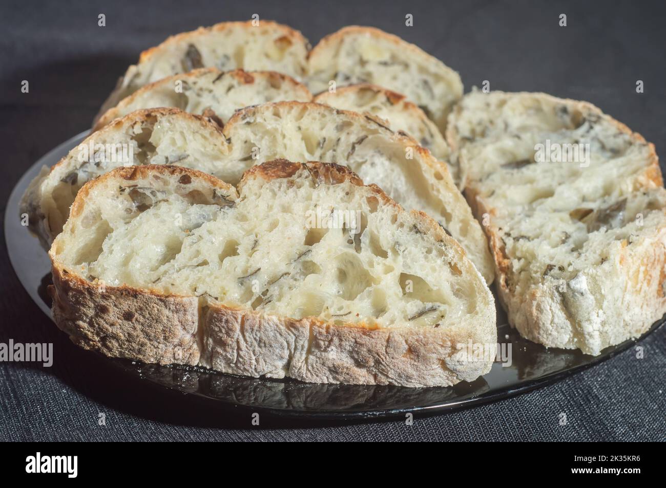 Handmade bread with natural fermentation placed on a black dish Stock