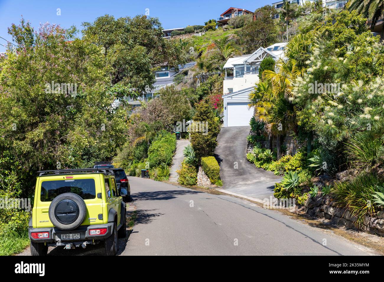 Suzuki Jimny in yellow parked in a street in Whale Beach suburb of Sydney, 4x4 small vehicle,NSW,Australia spring day Stock Photo