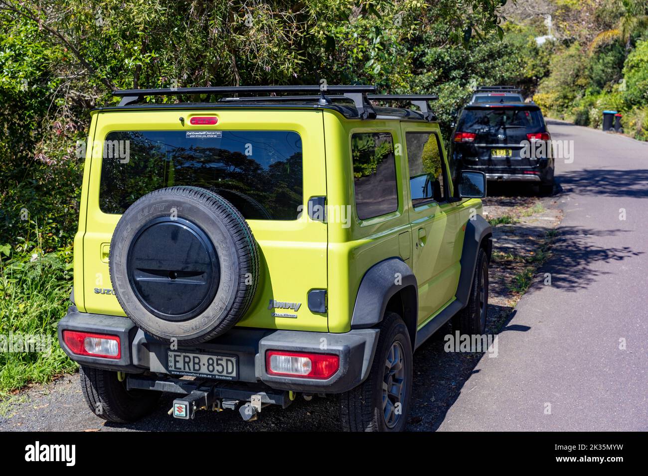 Suzuki Jimny in yellow parked in a street in Whale Beach suburb of Sydney, 4x4 small vehicle,NSW,Australia spring day Stock Photo