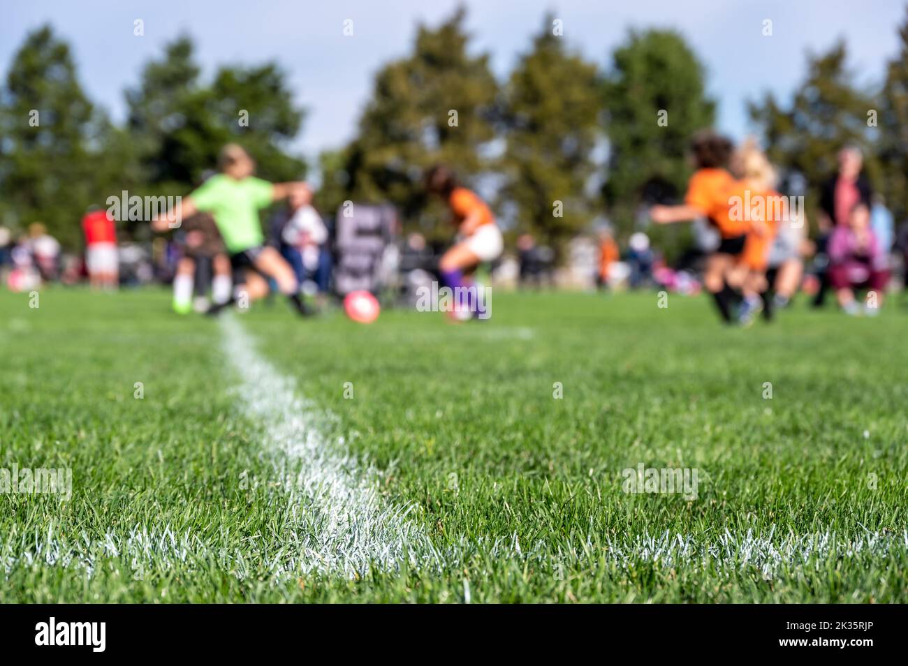 Selective focus on ground level view of soccer field center line with