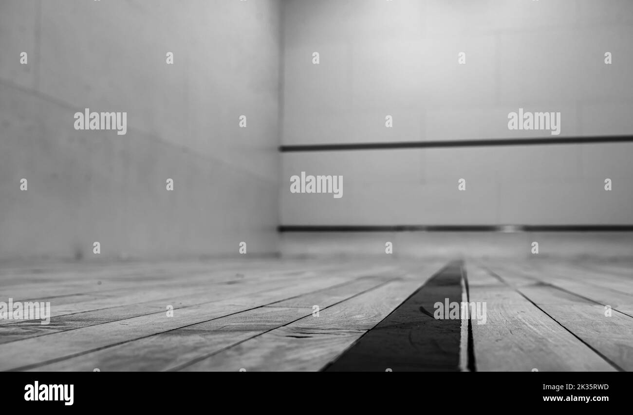 selective focus on a section of wood planking at floor level inside a racquet ball court Stock Photo