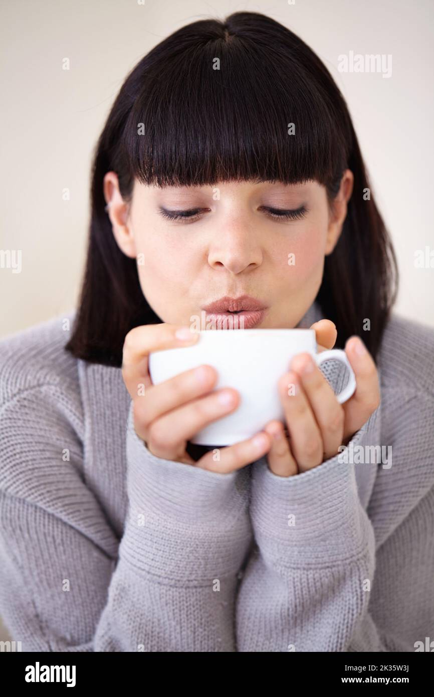 The best way to start the day a beautiful young woman enjoying a cup