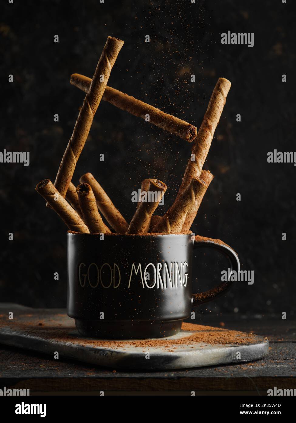 Cinnamon sticks in a black cup on a dark background. Closeup. Fragrant