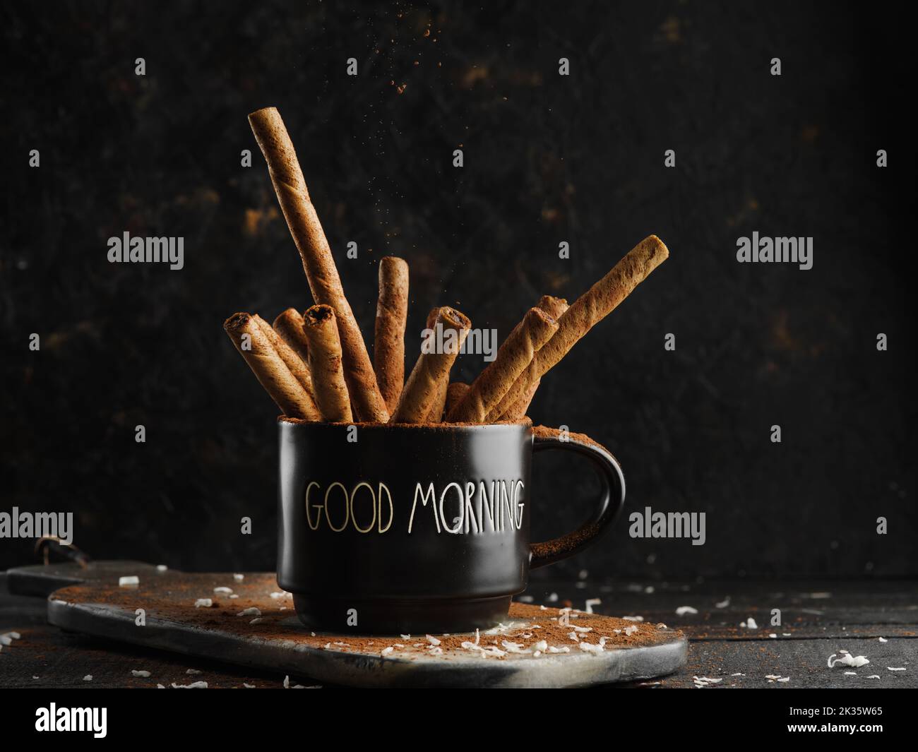 Aromatic spices, additives. Cinnamon sticks in a black cup on a dark background. Cooking. Sweet baking recipes. Recipe book, food blog. Restaurant, ho Stock Photo