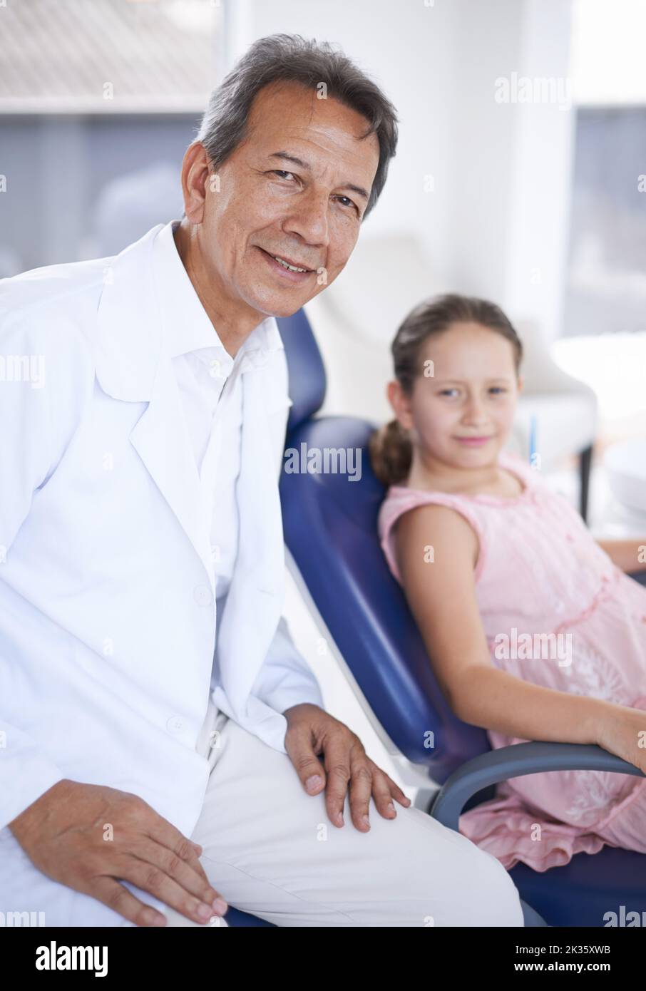 She trusts her dentist. A young girl at the dentist for a check-up. Stock Photo
