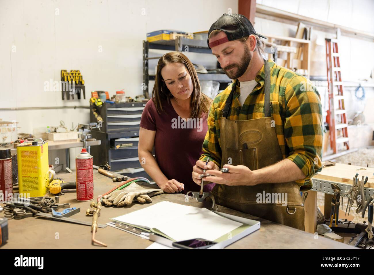 Bits and spurs makers collaborating in workshop Stock Photo
