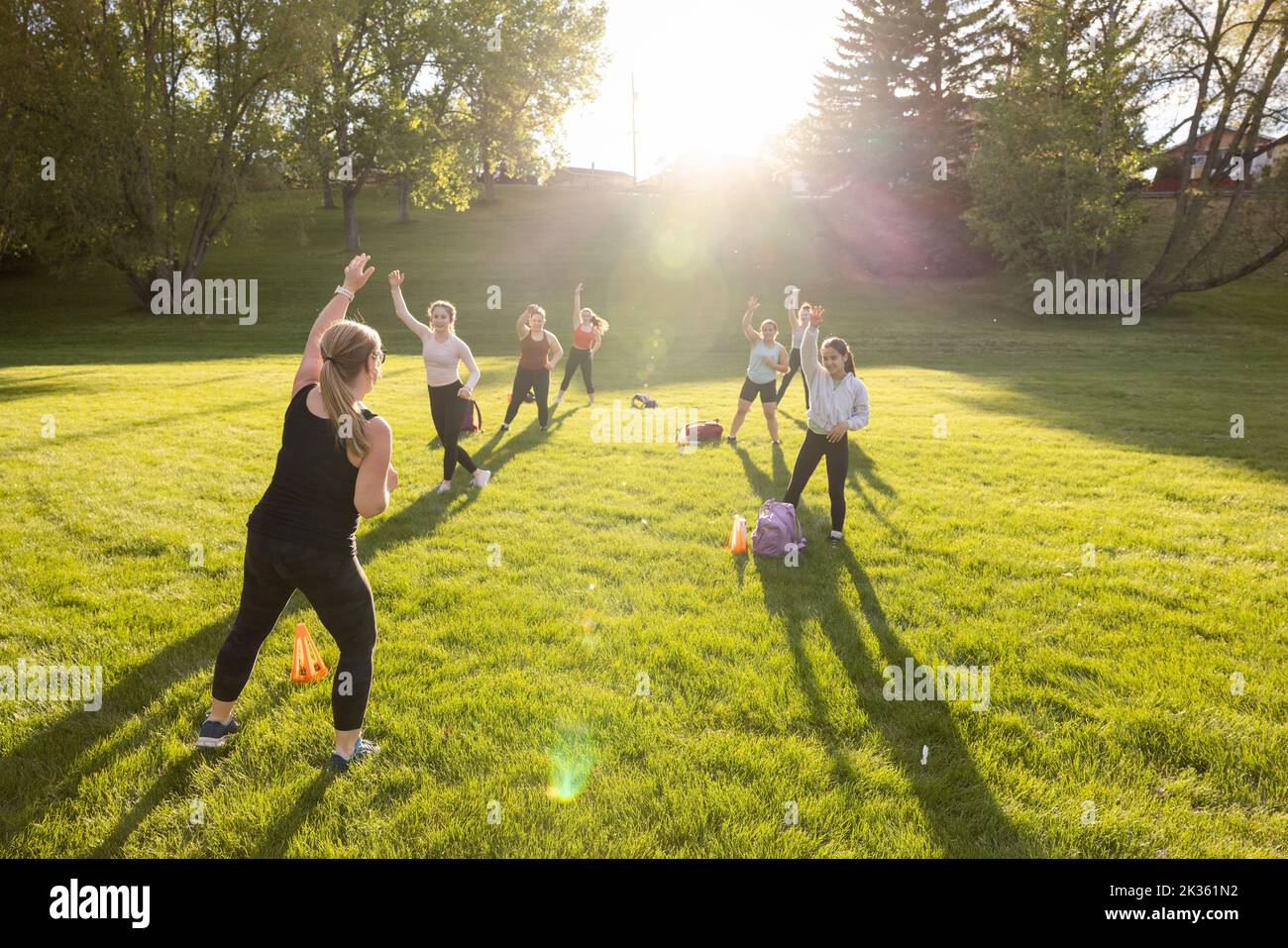 Fitness teacher conducting exercise in park Stock Photo
