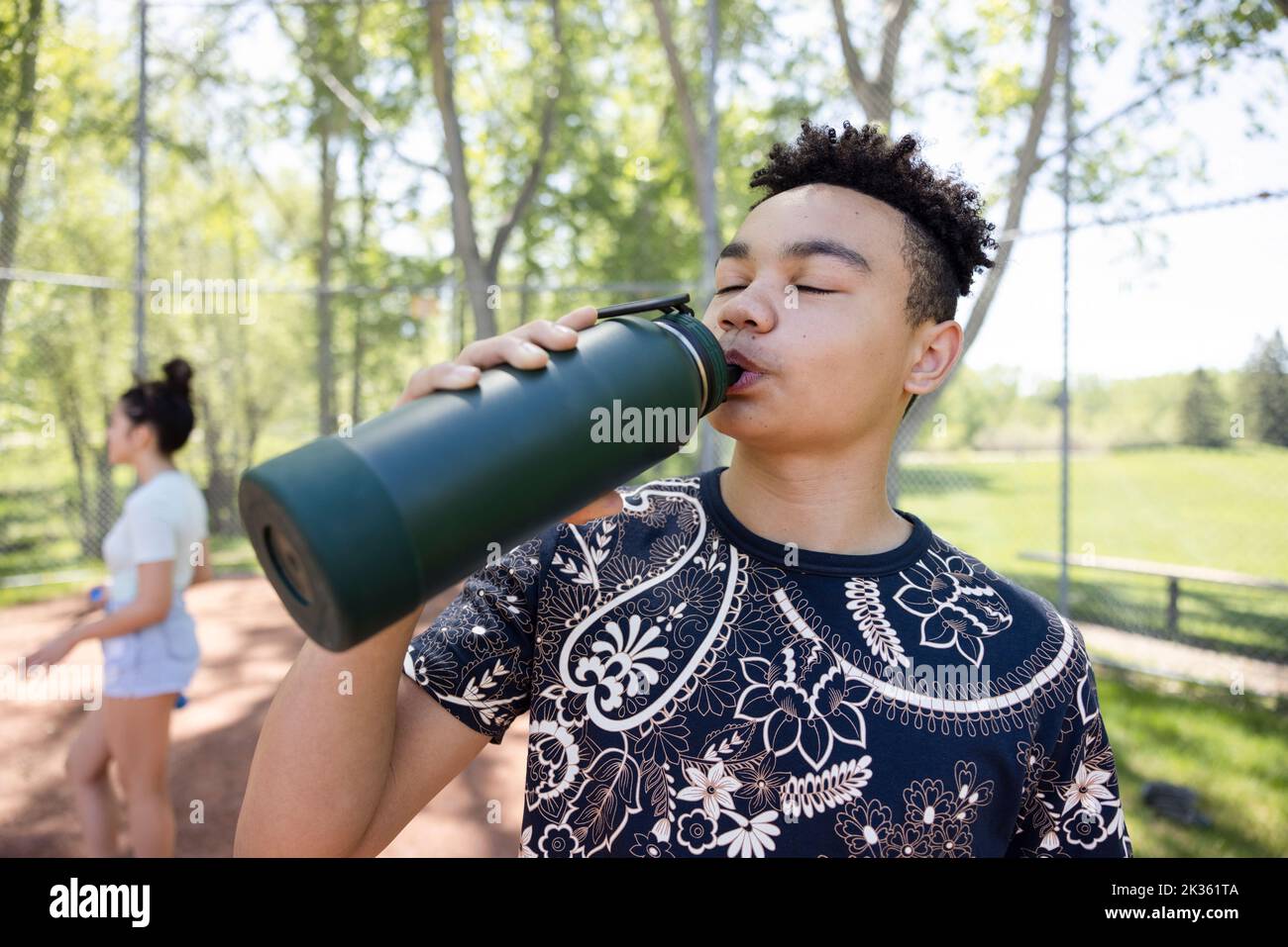 https://c8.alamy.com/comp/2K361TA/boy-enjoying-drink-from-water-bottle-in-baseball-field-2K361TA.jpg