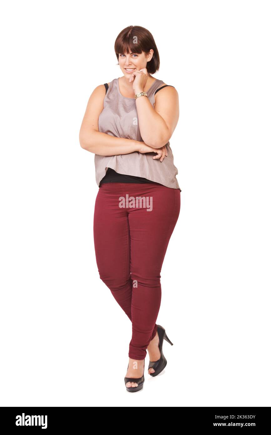 Plus size woman with deep cleavage and big breast posing in studio with  happy toothy smile. Overweight female model with curly dark hair looking in  camera Stock Photo